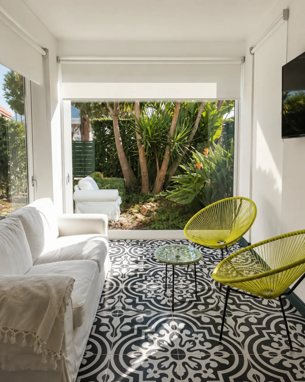 Salotto con divano e poltrone, vista sul giardino